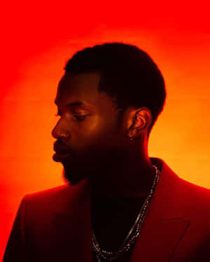 Manin Red Profile Against Orange Backdrop Wallpaper