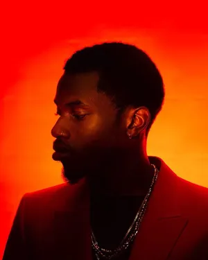 Manin Red Profile Against Orange Backdrop Wallpaper