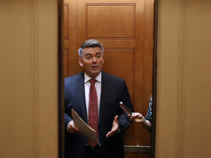 Manin Suit Surprisedat Doorway Wallpaper