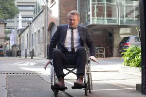 Manin Wheelchair Urban Setting Wallpaper