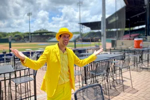 Manin Yellow Suitat Baseball Stadium Wallpaper