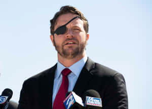 Manwith Eyepatch Speakingat Press Conference Wallpaper