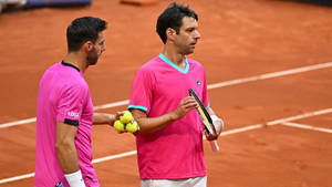 Marcel Granollers And Horacio Zeballos In Pink Wallpaper