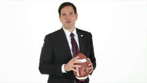 Marco Rubio Holding A Football Wallpaper