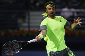 Marcos Baghdatis In Action, Speedily Aims For The Tennis Ball. Wallpaper