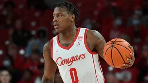 Marcus Sasser In Action On The Basketball Court Wallpaper