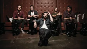 Maroon 5 Resting Brown Sofa Wallpaper