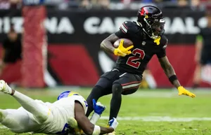 Marquise Brown Evading Tackle During Game Wallpaper