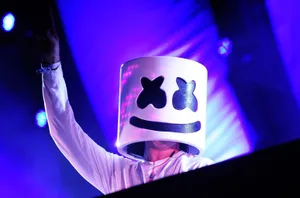 Marshmello Performing On A Neon-lit Blue Stage Wallpaper