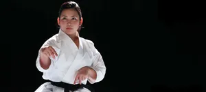 Martial Artists In Action Wearing Various Uniforms Wallpaper