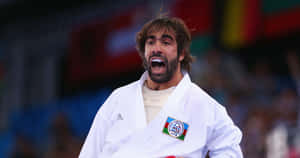 Martial Artists In Traditional Uniforms Displaying Their Skills Wallpaper