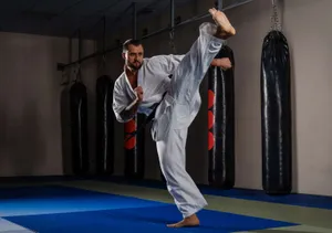 Martial Arts Expert Practicing Moves In Traditional Uniform Wallpaper