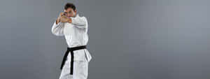 Martial Arts Practitioners In Various Uniforms Wallpaper