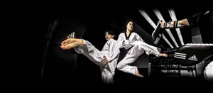 Martial Arts Practitioners Wearing Traditional Uniforms In Training Wallpaper