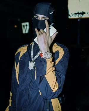 Masked_ Figure_with_ Gold_ Chains_and_ Watch Wallpaper