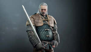 Masterful Vesemir In Action In A Dramatic Backdrop Wallpaper