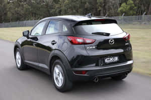 Mazda C X3 Rear View On Road Wallpaper