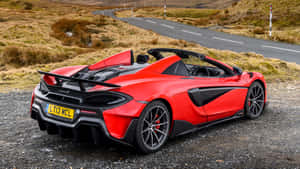 Mclaren 600lt Spider Cruising On The Open Road Wallpaper