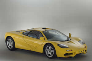 Mclaren F1 Speeding Down The Track Wallpaper