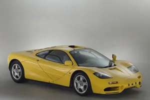 Mclaren F1 Speeding Down The Track Wallpaper