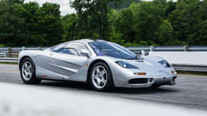 Mclaren F1 Speeding On The Road Wallpaper