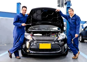 Mechanic Repairing A Car Engine Wallpaper