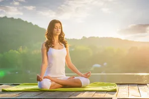 Meditative Person Practicing Yoga In Nature Wallpaper