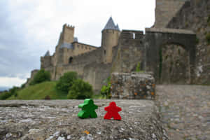 Meeples Outside The Castle In Carcassonne France Wallpaper