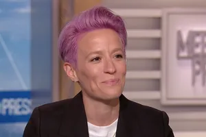 Megan Rapinoe In Action On The Soccer Field Wallpaper