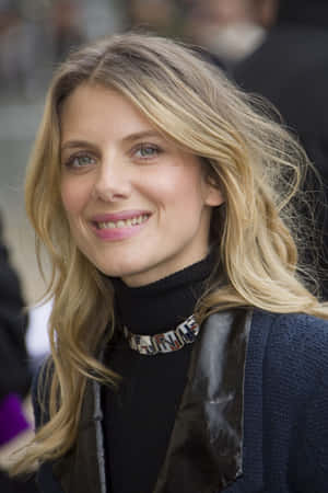 Mélanie Laurent Posing Elegantly Against A Neutral Background Wallpaper