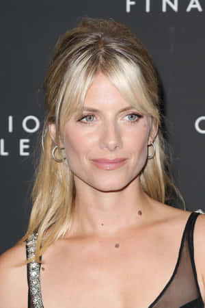 Mélanie Laurent Posing Gracefully Against A Light Background Wallpaper