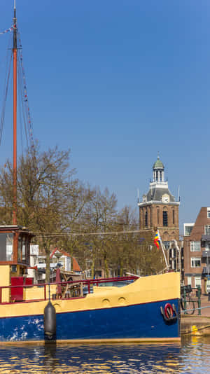 Meppel Cityscapewith Historic Churchand Boat Wallpaper