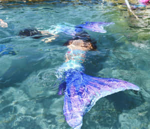 Mermaid Tail Swimmingin Crystal Waters Wallpaper