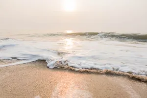 Mesmerizing Beach Waves At Sunrise Wallpaper