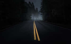 Mesmerizing Dark Road Through Twilight Forest Wallpaper