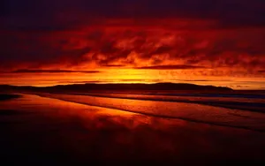 Mesmerizing Red Sunset At The Beach Wallpaper