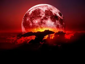 Mesmerizing Strawberry Moon Illuminating The Night Sky Wallpaper