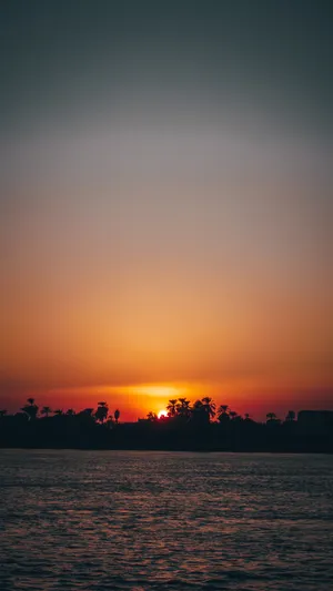 Mesmerizing Sunset Hues Over The Horizon Wallpaper
