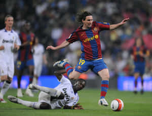 Messi_ Evading_ Tackle_ During_ Match Wallpaper