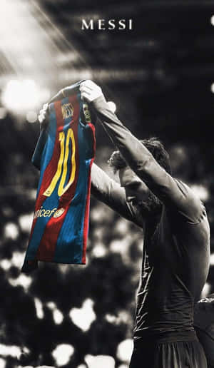 Messi Holding Barcelona Jersey Wallpaper