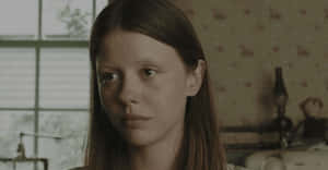 Mia Goth Serious Expression Wallpaper