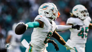 Miami Dolphins Player Celebratingon Field Wallpaper