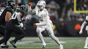 Miami Dolphins Playerin Action Against New York Jets Wallpaper