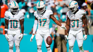 Miami Dolphins Players Walkingon Field Wallpaper