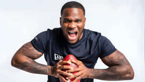 Micah Parsons Intense Football Pose Wallpaper