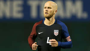 Michael Bradley Jogs At The Field Wallpaper