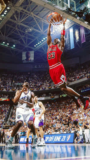 Michael Jordan Gracefully Throws A Dunk. Wallpaper