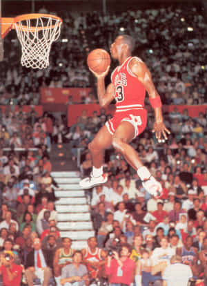 Michael Jordan In Midair During A Gravity-defying Dunk Wallpaper