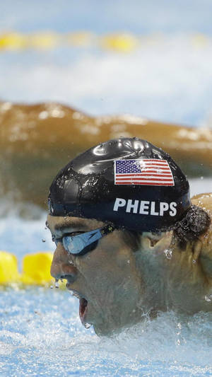 Michael Phelps Holding The Usa Flag With Pride Wallpaper