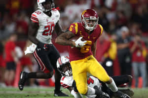 Michael Pittman Jr Evading Tackle During Game Wallpaper